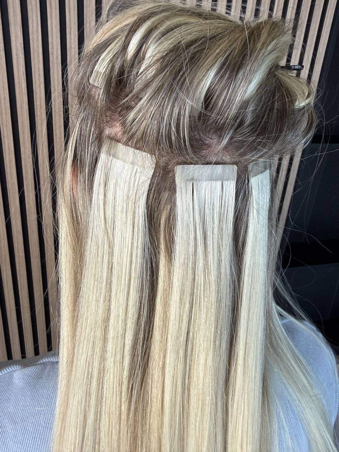 Tape-in extensions close-up – flat 4 cm wide bonds against the scalp